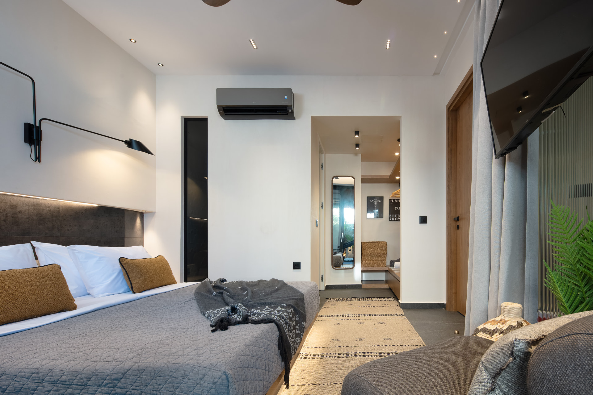 Bedroom two with king bed, soft lighting and direct terrace access