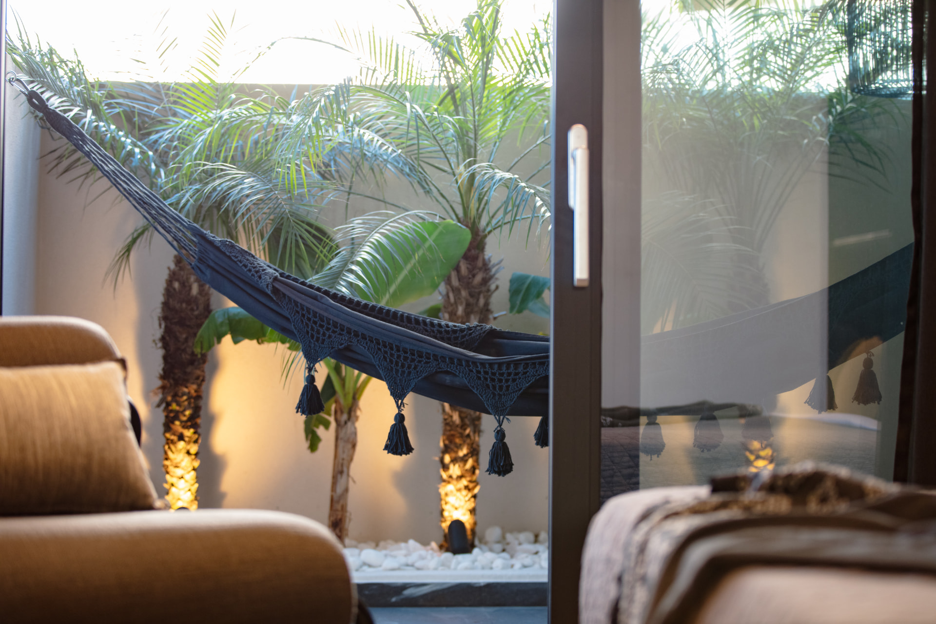 Hammock and palm garden seen from inside the villa