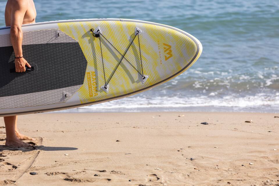 SUP board on the sand at the water's edge