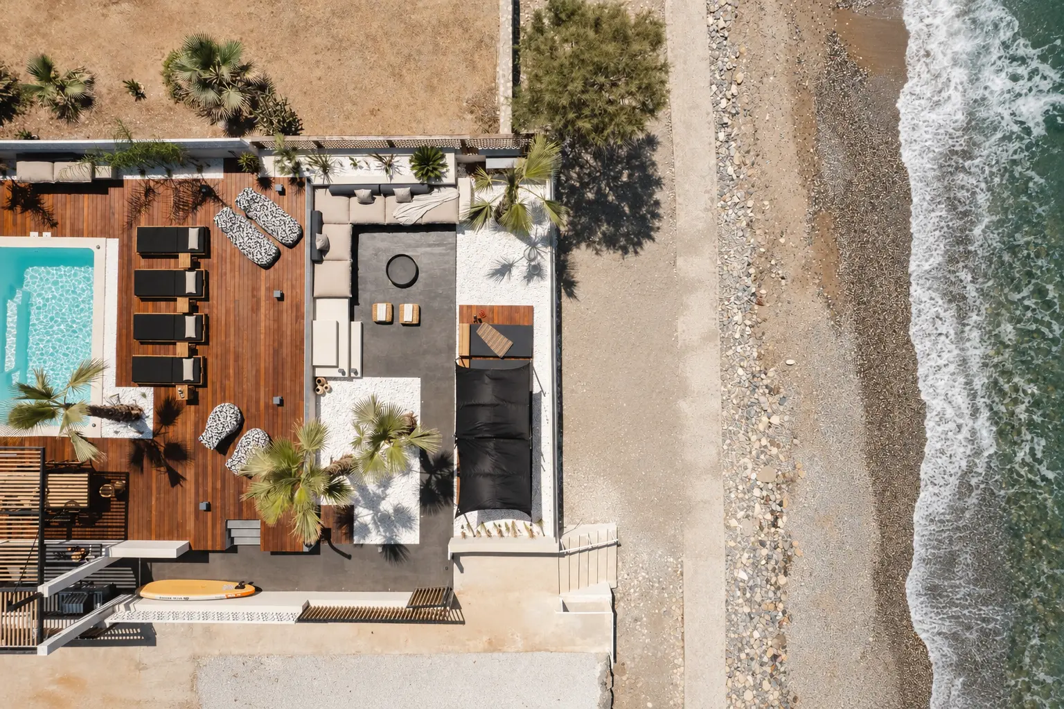 Aerial view of Casa Negro's terrace and pool beside the beach